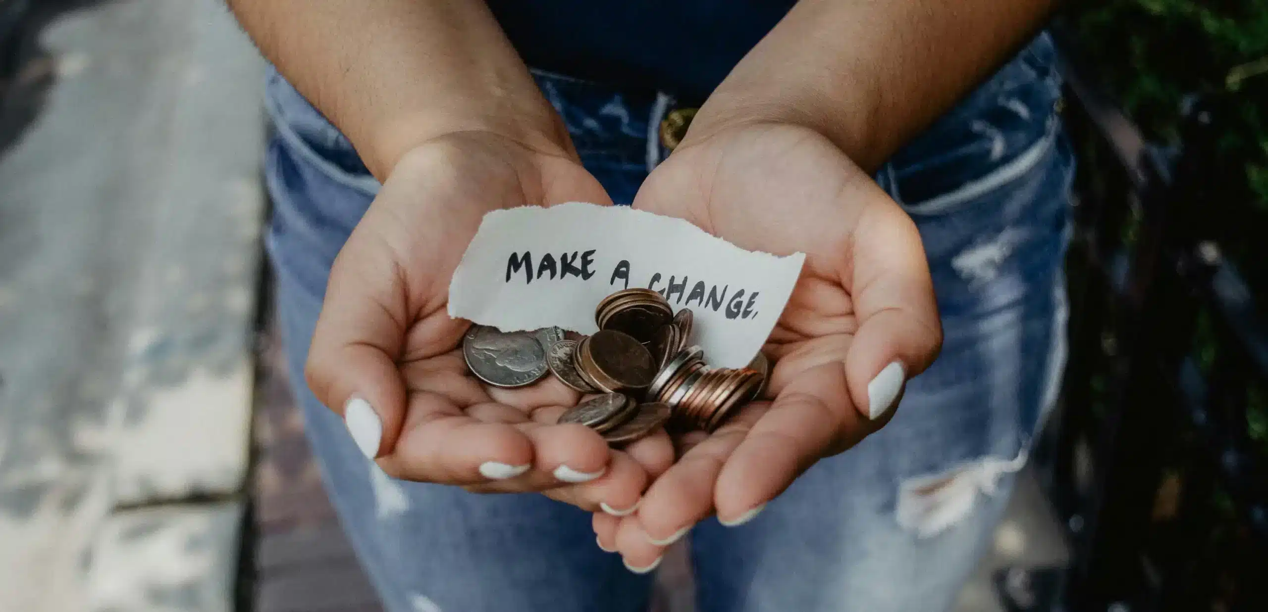 a person with money in hand representing the cost of a carbon footprint