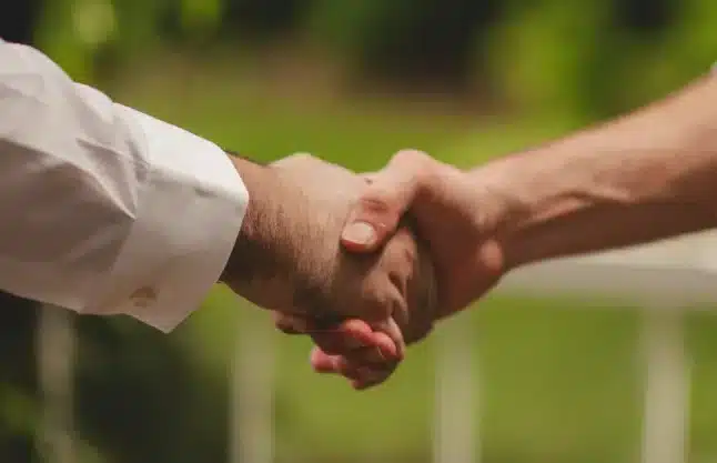 A handshake between people showing the trust engendered by carrying out a carbon accounting