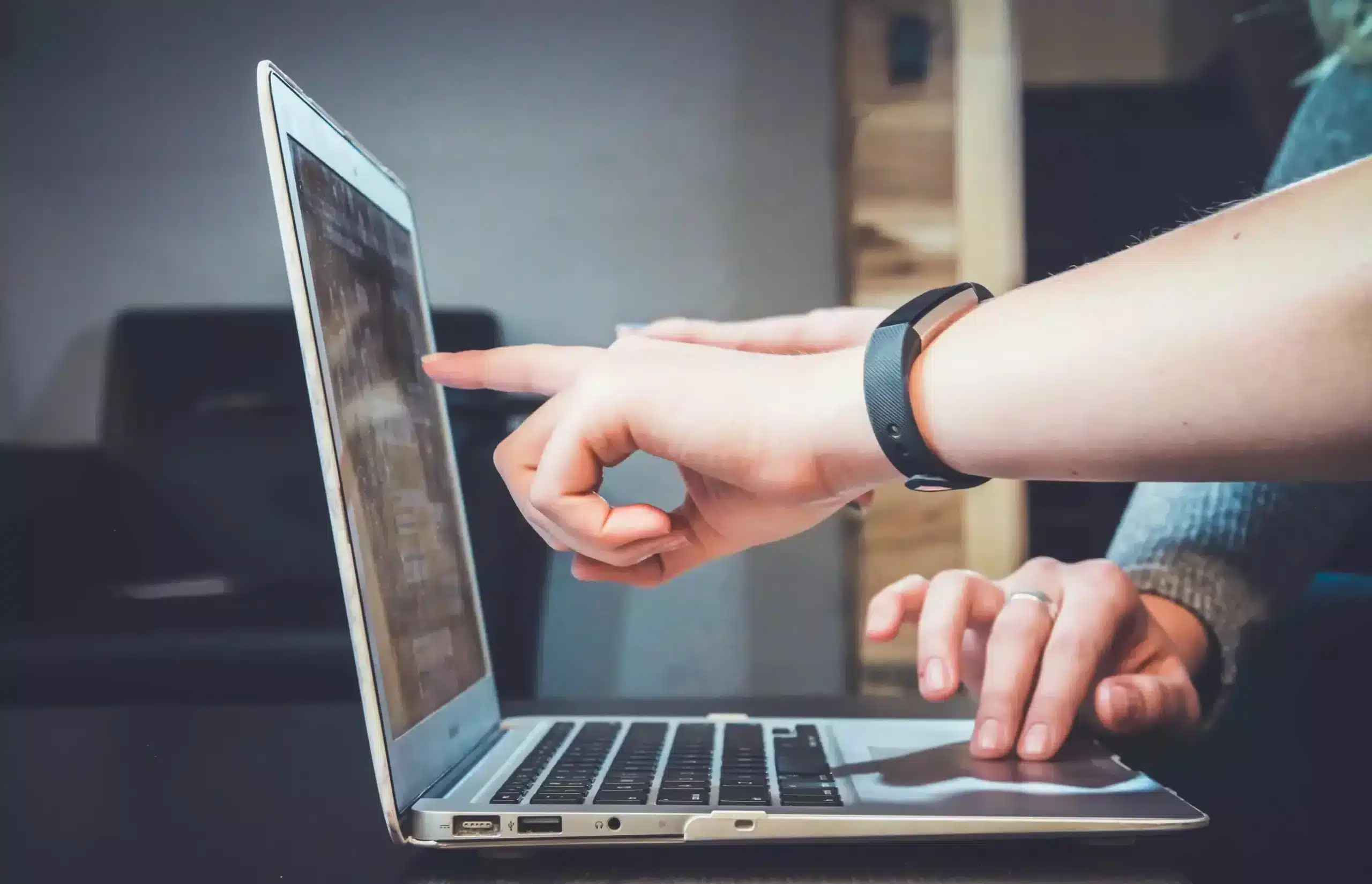 A finger pointing at a computer screen displaying the results of a carbon accounting