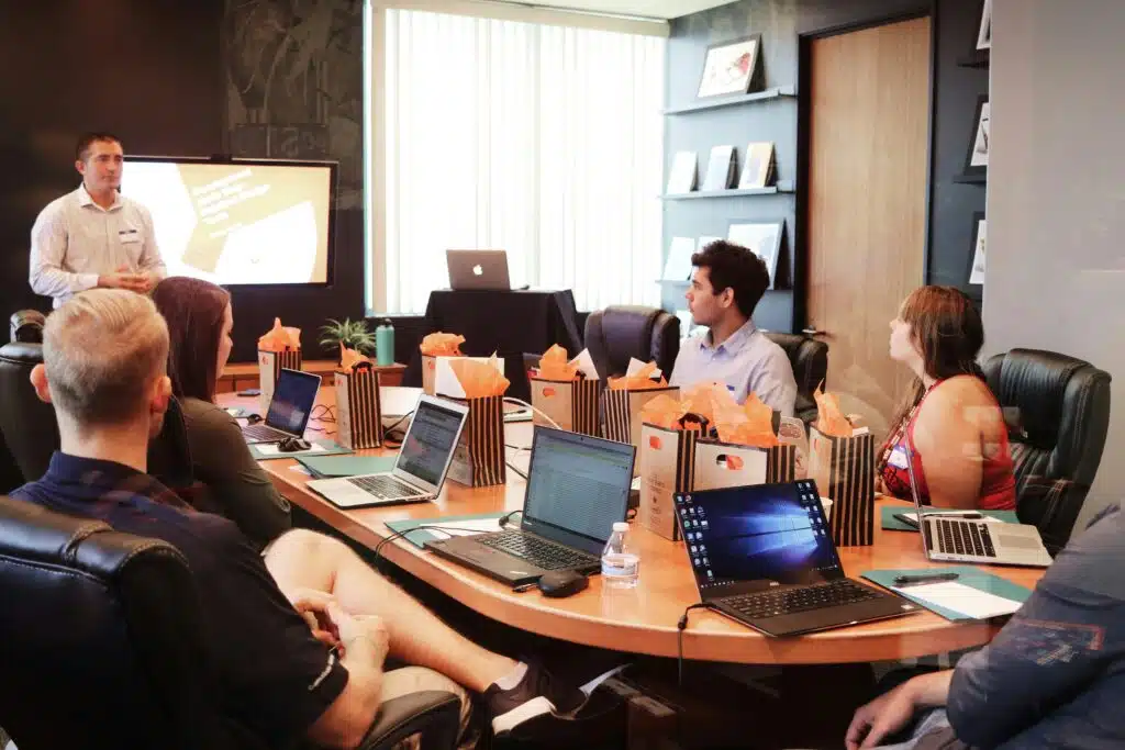 Group of partners attending a training program around a table.